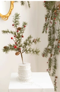Detail of Christmas pine branch with red berries, natural pine cones and festive bells