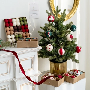 Christmas wool felt ball ornaments set with snowflake patterns in a kraft gift box