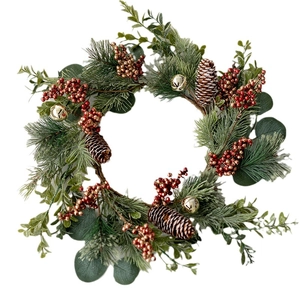 Classic Christmas wreath with pine needles, red berries, pinecones and gold bells decoration