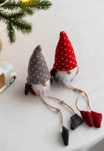 Close-up of Christmas gnomes with knitted hats and long rope legs for festive decor