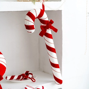 Red and white velvet candy cane Christmas tree hanging ornament with a classic red bow