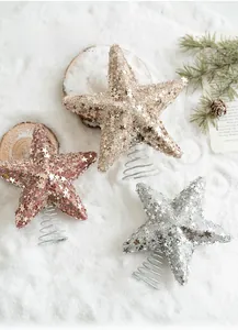 Glittery gold pink and silver Christmas star toppers on spring bases with pine branches