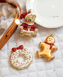 Close-up of glittery Christmas tree ornaments including Santa bear and gingerbread man