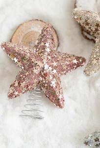 Macro detail of rose gold Christmas tree topper with glitter sequins and metal spring base