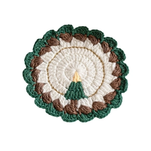 Handmade crochet Christmas coaster with green tree pattern and scalloped edges