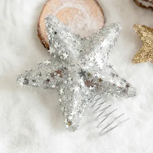 Sparkling silver glitter star tree topper with spring base on festive snow background