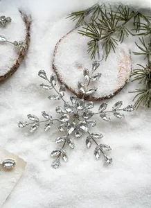 Detailed view of silver acrylic snowflake ornament with inlaid sparkling rhinestones