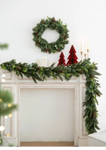Christmas PE pine wreath and garland set with pine cones on a festive fireplace mantel