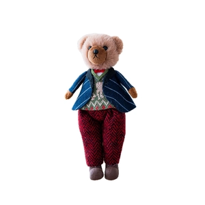 Gentleman style plush teddy bear in navy striped suit and red bow tie on white background
