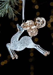 Macro shot of reindeer Christmas ornament with gold sequins and transparent resin texture