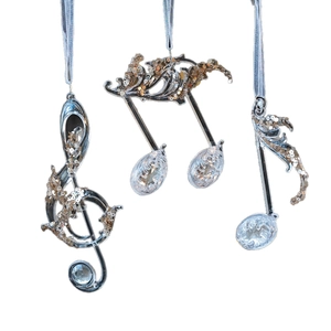 Three-piece musical note Christmas ornaments with silver frames and gold glitter accents