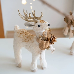 White Christmas reindeer centerpiece with golden glitter antlers and pinecone decor