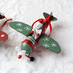 Retro metal airplane Christmas ornament with snowman pilot and white snowflake patterns