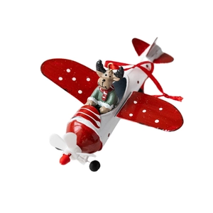Christmas reindeer in metal airplane tree ornament with red silk cord on white backdrop