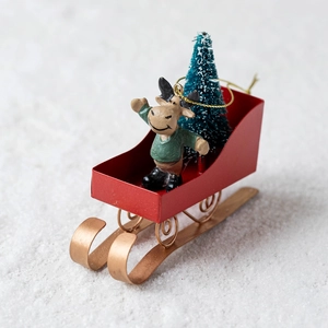 Christmas sleigh decoration with miniature reindeer and frosted tree on red metal base