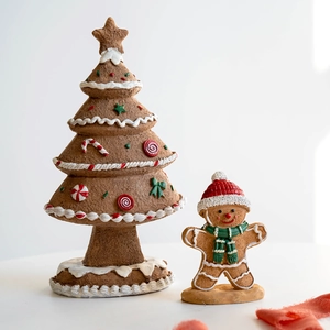 Resin gingerbread man and Christmas tree tabletop ornaments with festive cream decorations