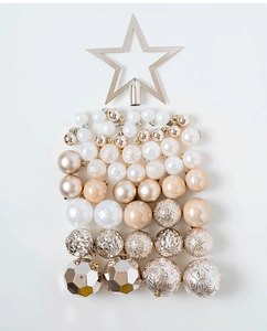 Flat lay of champagne gold Christmas ball ornaments and star topper shaped as a tree