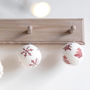 Red and white flocked Christmas ball ornaments with snowflake and tree patterns