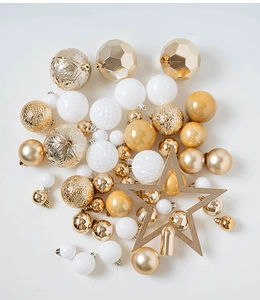 Close-up of mixed texture Christmas ball ornaments with champagne gold star topper