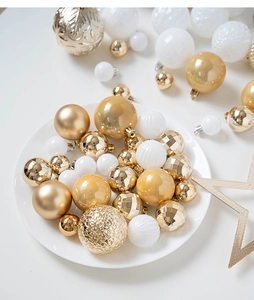 Macro shot of assorted gold and white Christmas balls with glitter and matte textures
