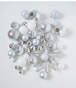 Close-up of silver and white Christmas baubles set with star tree topper and textures