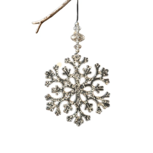 Acrylic Christmas snowflake ornament with silver glitter hanging on a branch