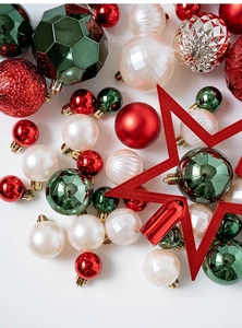 Macro shot of red, green, and white Christmas ornaments with glittered star topper set