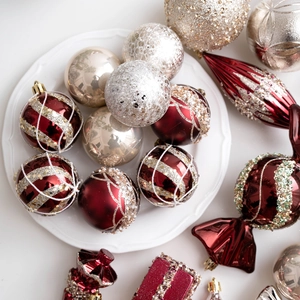 Set of champagne and red Christmas ornaments including baubles and candy shapes
