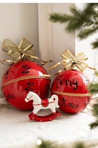 Detailed view of red Christmas bell ornaments with Merry Christmas text and a white rocking horse