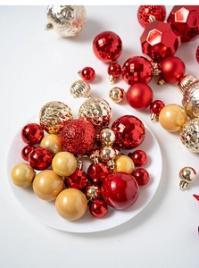 Detail of red and gold Christmas ornaments with various textures and a star tree topper