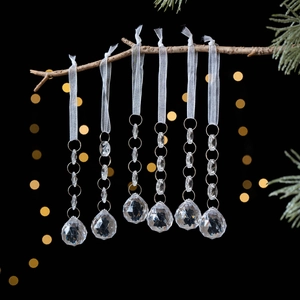 Set of 6 acrylic crystal snowflake and icicle ornaments hanging on a branch for Christmas decor