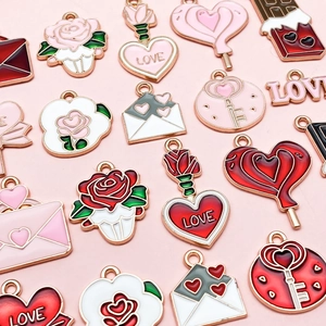 Detailed close-up of Valentine alloy charms including pink love letters and hearts for DIY