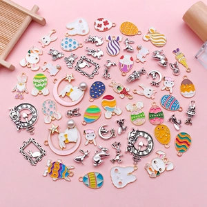 Detailed flat lay of colorful enamel Easter egg and bunny alloy pendants for DIY jewelry