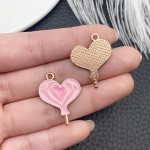 Macro detail of heart-shaped enamel charms with rose gold back for DIY jewelry