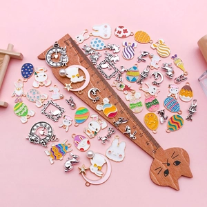 Detailed flat lay of colorful Easter enamel charms featuring bunny and egg designs