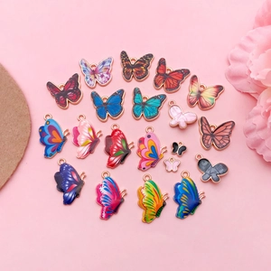 Macro detail of colorful butterfly pendants with floral enamel patterns and gold plating