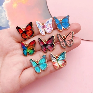 Eight colorful butterfly alloy pendants with gold trim for DIY necklaces and bracelets