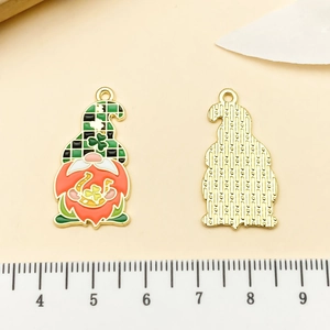 Detail of St. Patrick's Day gnome pendant showing size scale and green enamel finish