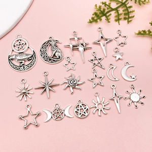 Detail view of antique silver moon and star charms for DIY jewelry making sets