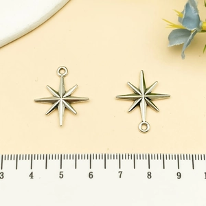 Detailed view of two vintage silver star charms measuring 2.2 cm for DIY jewelry making