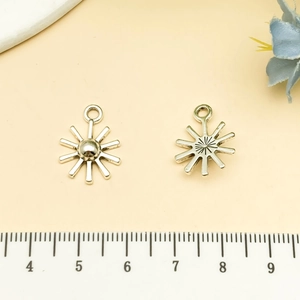 Silver sun pendants with radiant design and ruler showing 1.5cm size for DIY jewelry