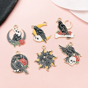 Macro shot of 6 Gothic style enamel alloy charms with sun, moon, and skull designs