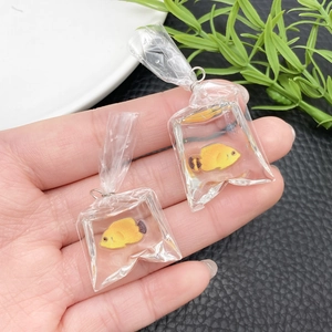 Close-up of creative resin goldfish in water bag pendant with vibrant yellow fish detail