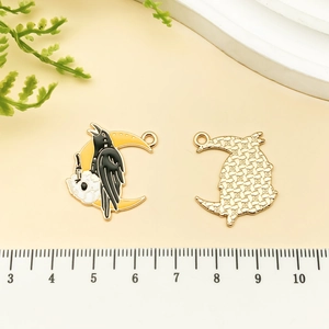 Detail of gothic crow and moon enamel pendant showing both front and metal back