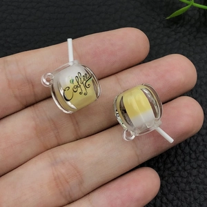 Close-up of miniature glowing resin coffee cup pendant for DIY keychain and jewelry crafts
