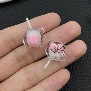 Macro detail of pumpkin shaped resin coffee cup charms with dual-tone pink filling