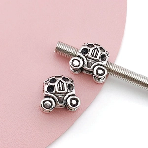Detail of vintage silver carriage beads with intricate hollow carvings for DIY jewelry