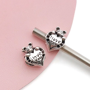 Detailed macro view of heart bear charms with love you engraving for DIY bracelets