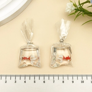Top view of creative goldfish water bag resin charms for DIY earring and jewelry making