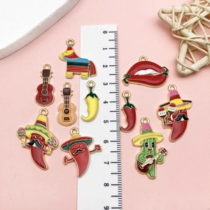 Macro shot of Mexican themed enamel charms including cactus and chili for DIY jewelry